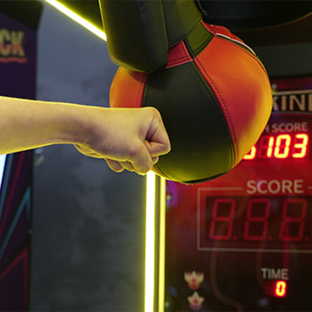 Fist Hitting An Arcade Punching Bag